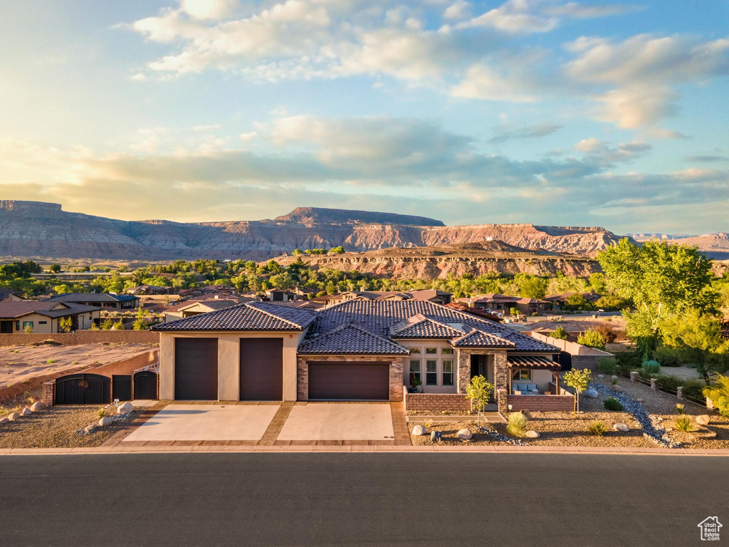 View of front of property with a garage and a mountain view