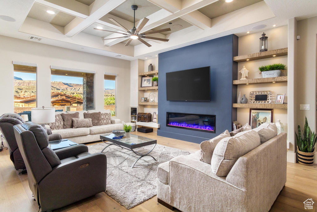 Living room featuring coffered ceiling, ceiling fan, and light hardwood / wood-style flooring