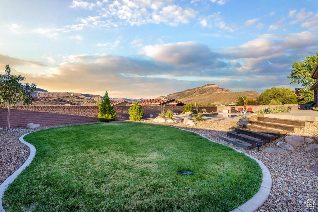 Yard at dusk with a mountain view