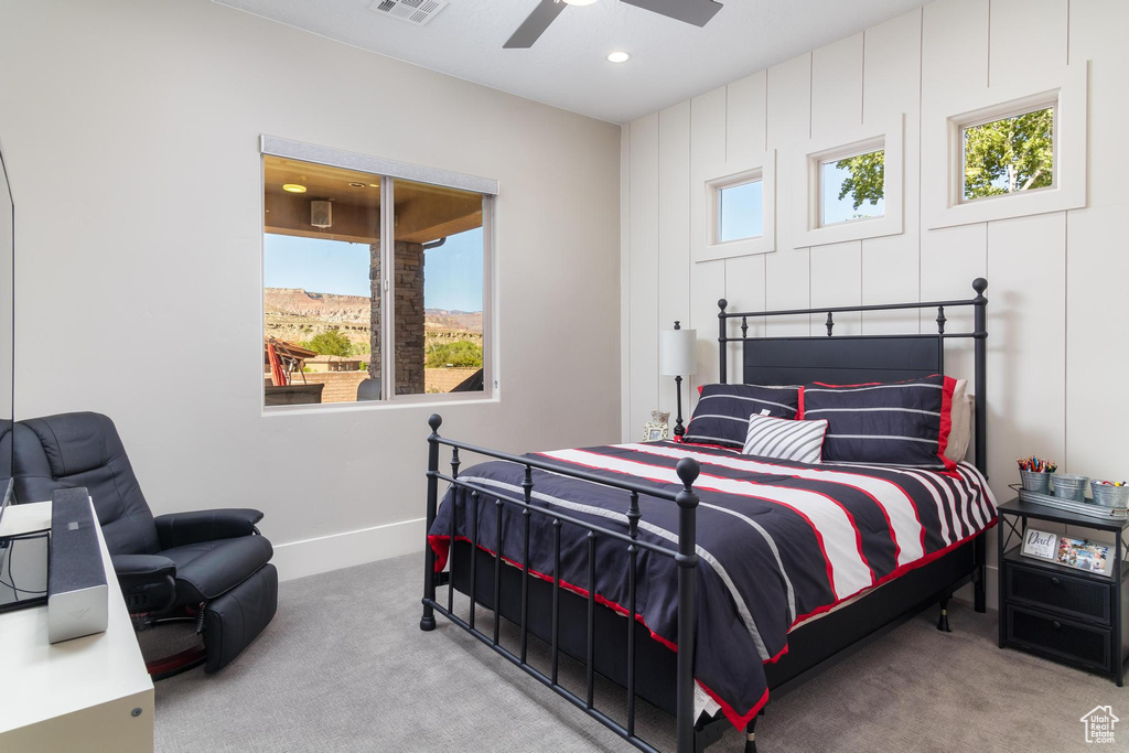 Carpeted bedroom featuring ceiling fan