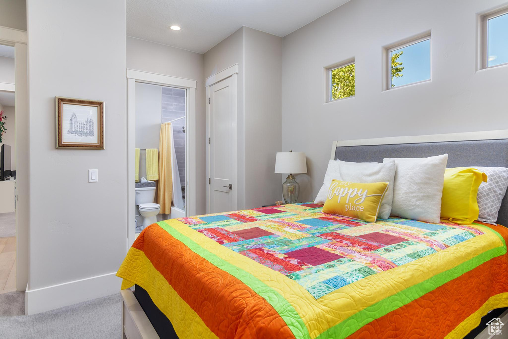 Bedroom with ensuite bathroom and carpet floors