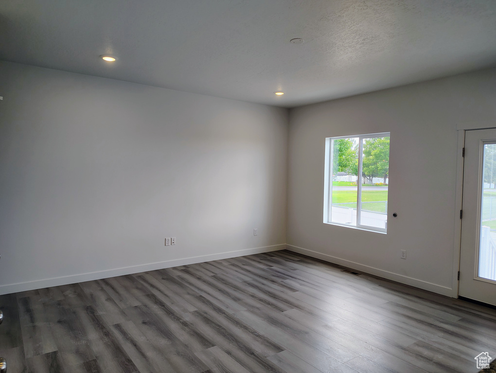 Empty room with hardwood / wood-style floors