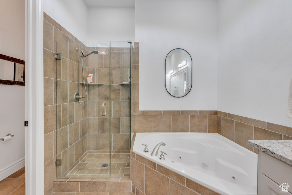 Bathroom with plus walk in shower, tile patterned floors, and vanity