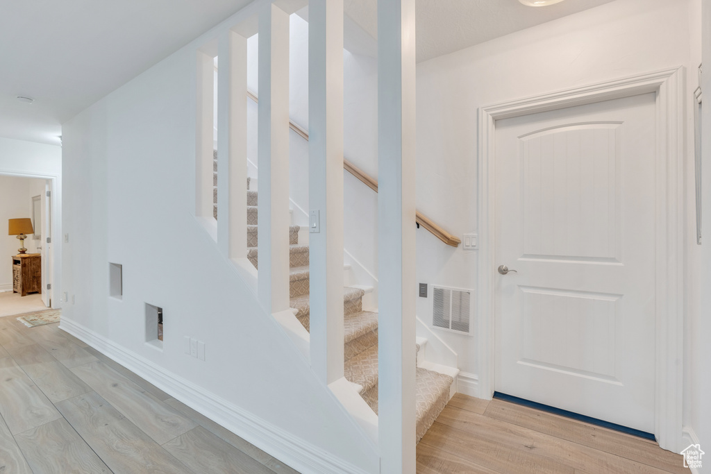 Stairway with hardwood / wood-style floors