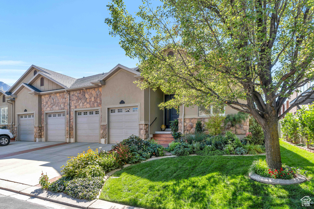 View of front of house with a front lawn and a garage