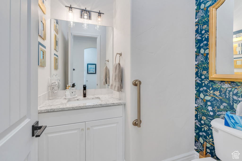 Bathroom featuring vanity and toilet