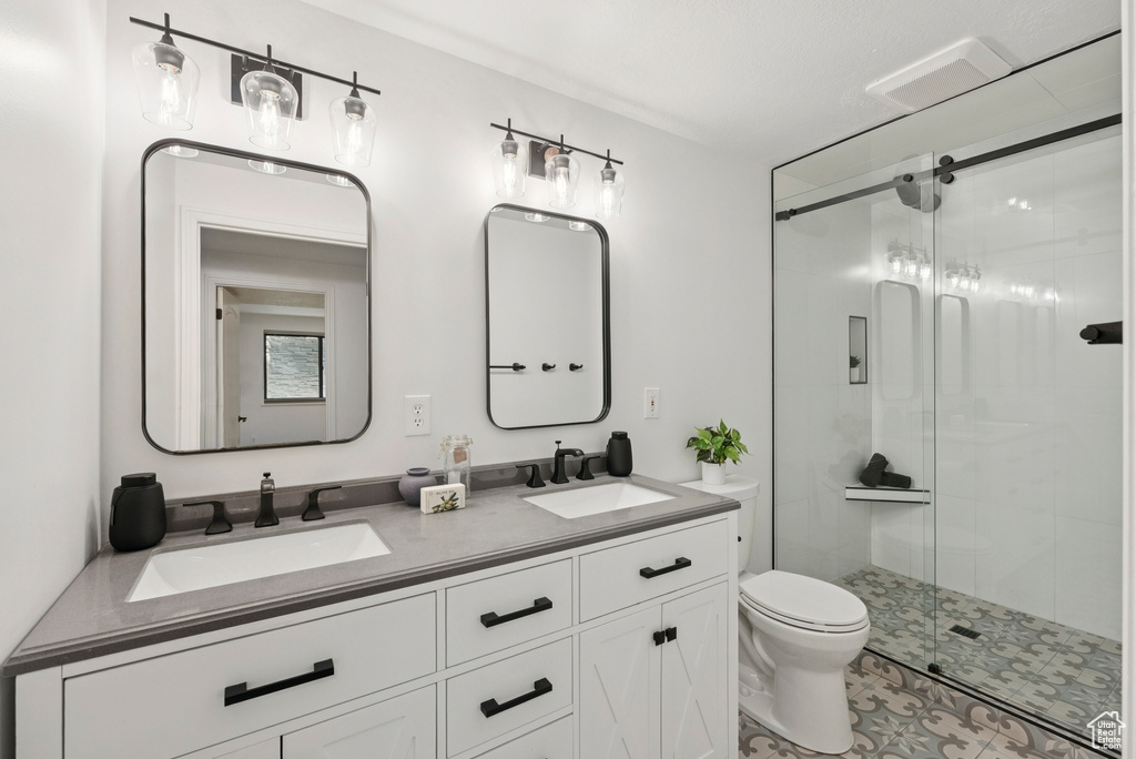 Full bath with a shower stall and double vanity