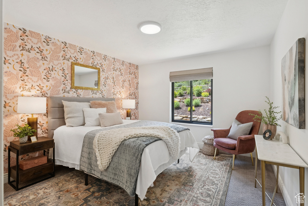 Bedroom featuring wallpapered walls