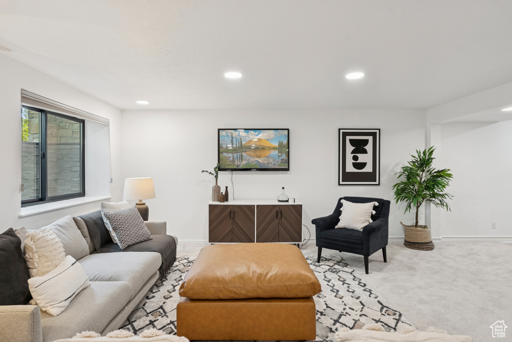 Carpeted living room with recessed lighting and baseboards