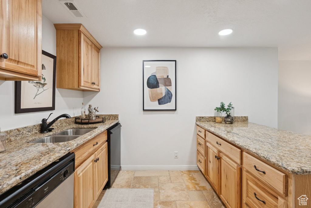 Kitchen with dishwasher, a peninsula, light stone countertops, light brown cabinetry, and recessed lighting