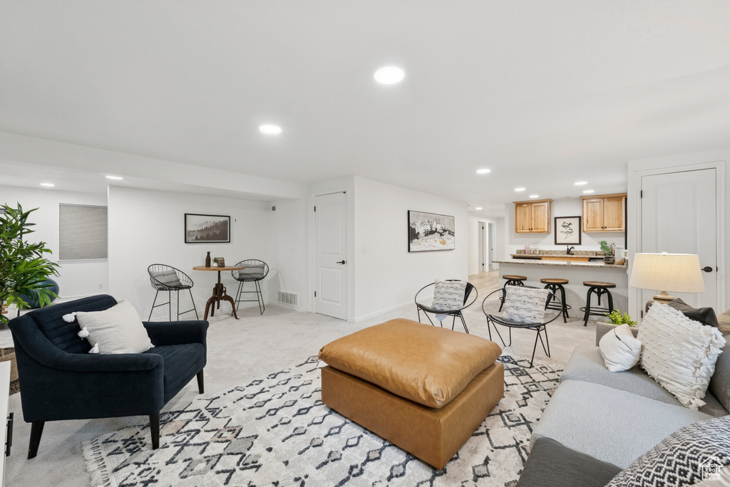 Living area featuring recessed lighting and light colored carpet