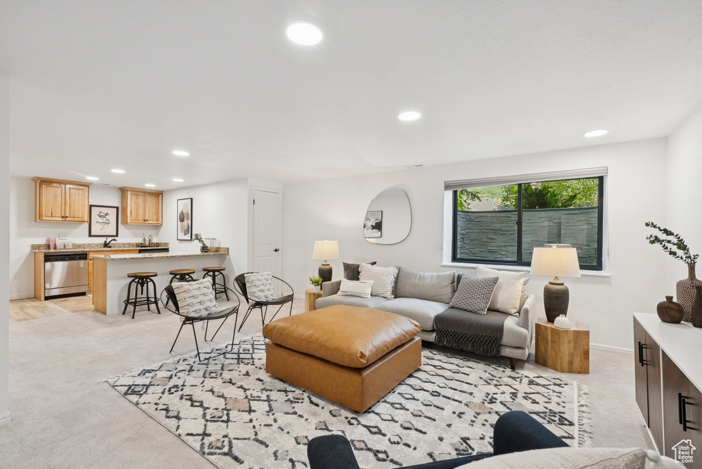 Living area with recessed lighting and light colored carpet