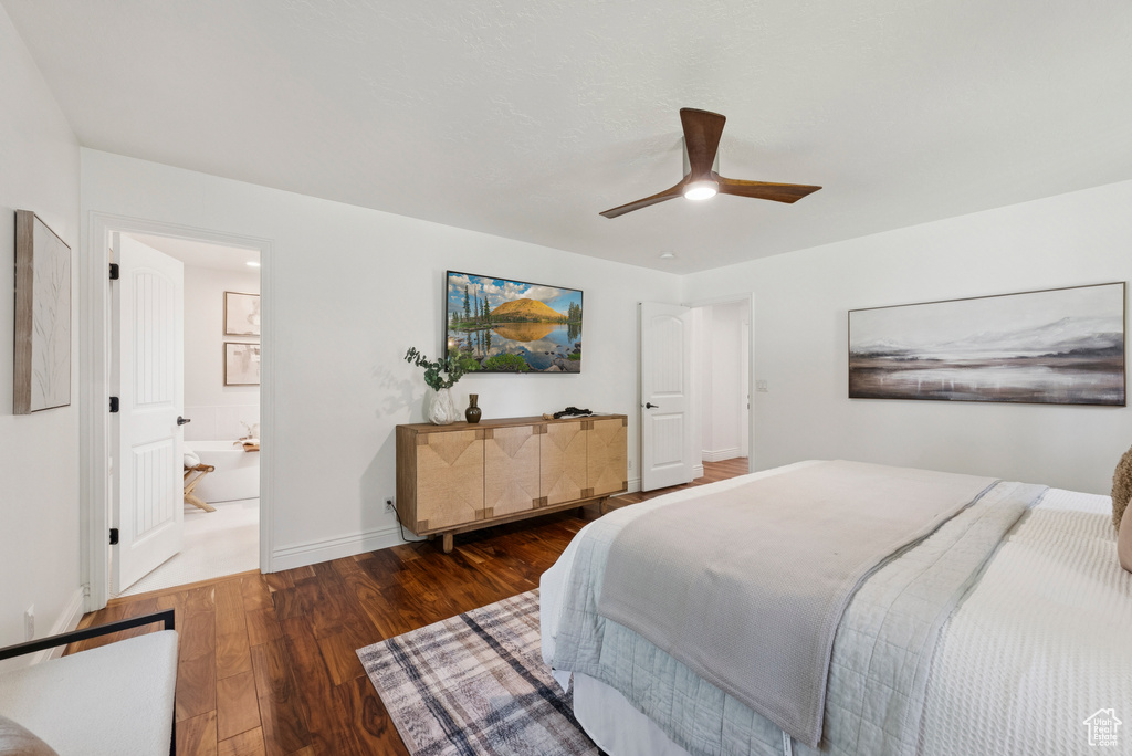 Bedroom with wood finished floors, a ceiling fan, and ensuite bathroom