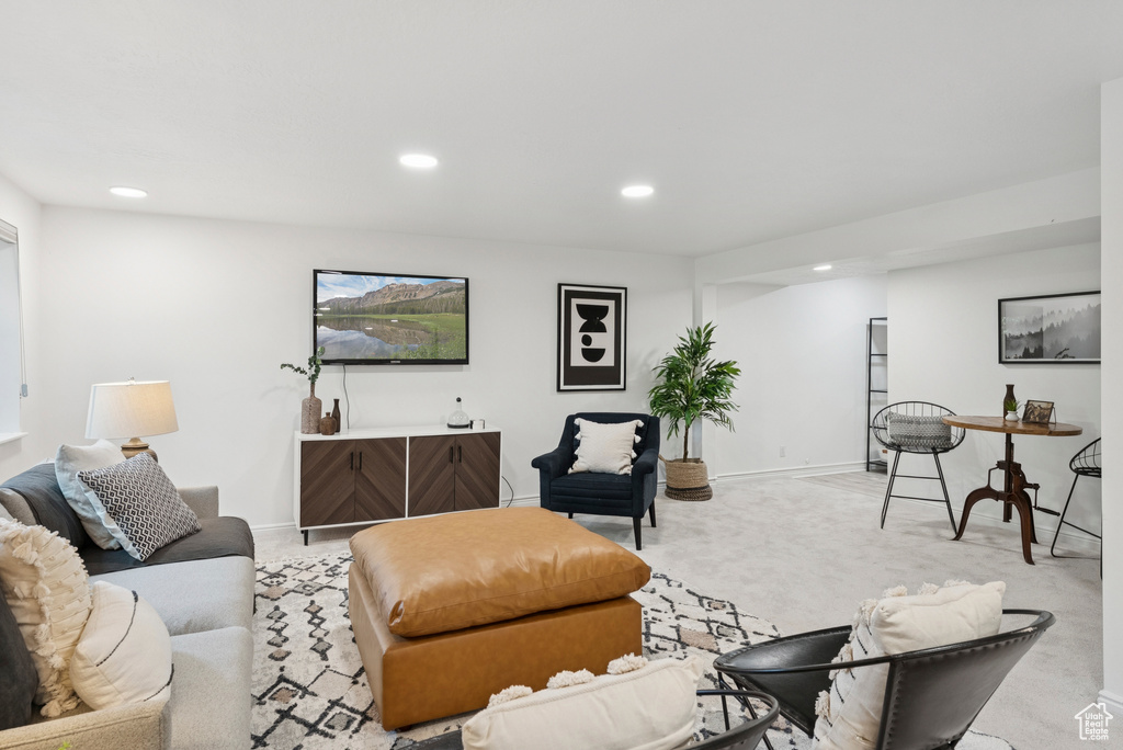 Living room with recessed lighting and light colored carpet