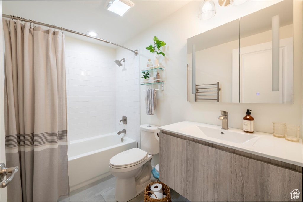 Full bathroom featuring vanity, tile patterned floors, toilet, and shower / bath combo