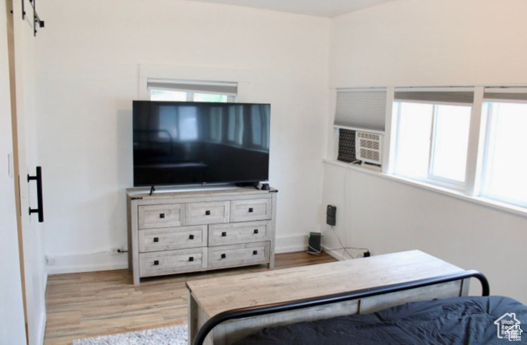 Bedroom featuring cooling unit and light hardwood / wood-style floors