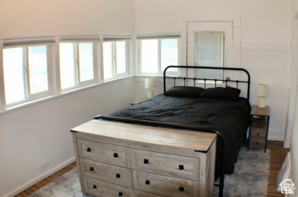 Bedroom with hardwood / wood-style flooring