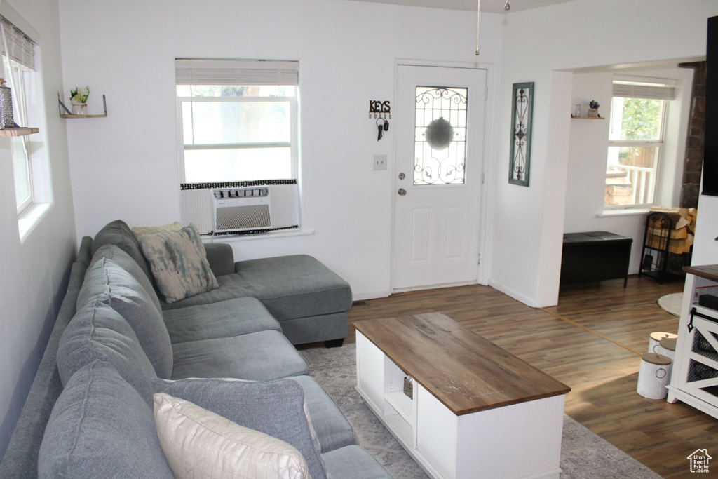 Living room with cooling unit and dark hardwood / wood-style floors