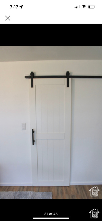 Interior space featuring a barn door and hardwood / wood-style flooring