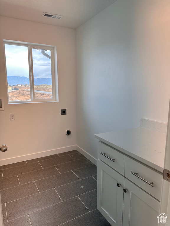 Washroom with a mountain view and hookup for an electric dryer