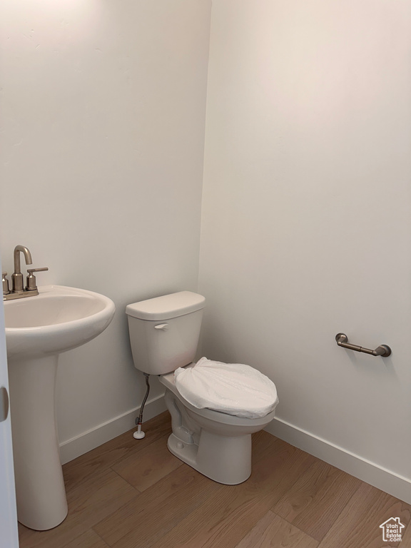 Bathroom with sink, toilet, and hardwood / wood-style floors