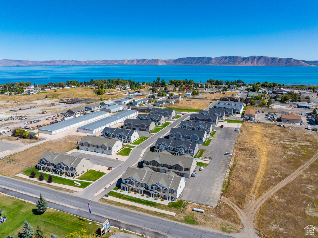 Birds eye view of property with a water and mountain view