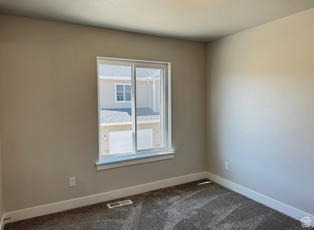 Spare room featuring carpet