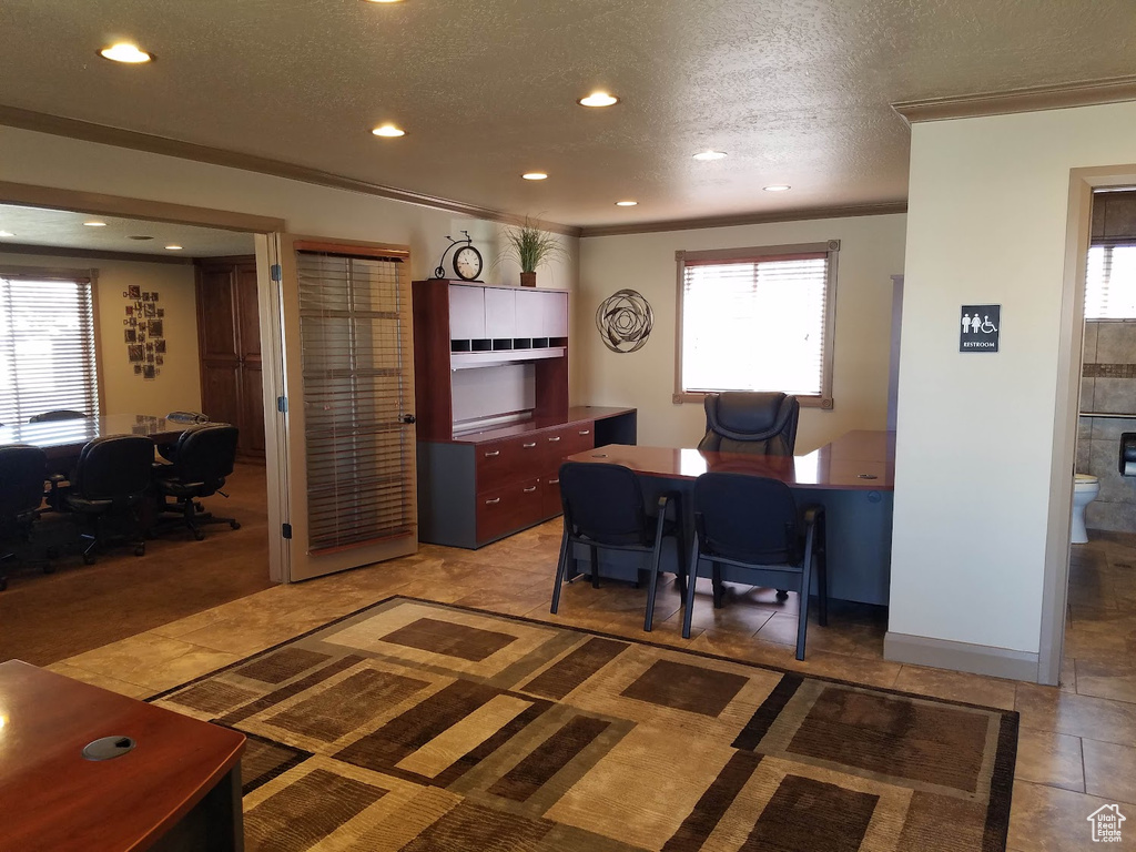 Carpeted office with a textured ceiling and crown molding