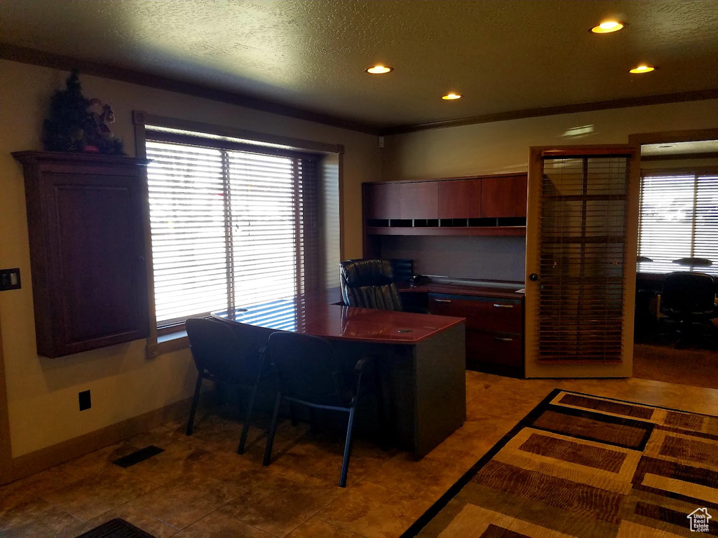 Kitchen with a textured ceiling and tile patterned flooring