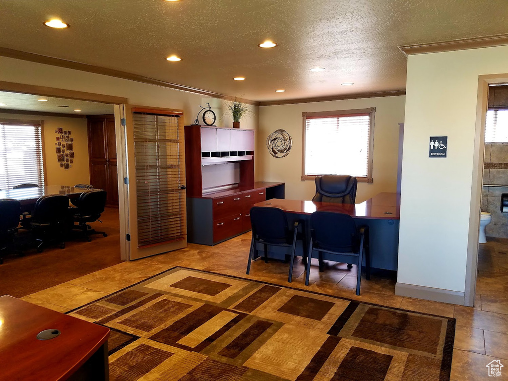 Home office with a textured ceiling, ornamental molding, and a wealth of natural light