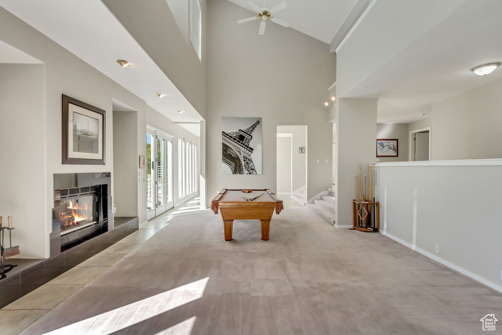 Playroom featuring billiards, a tile fireplace, a high ceiling, carpet flooring, and ceiling fan