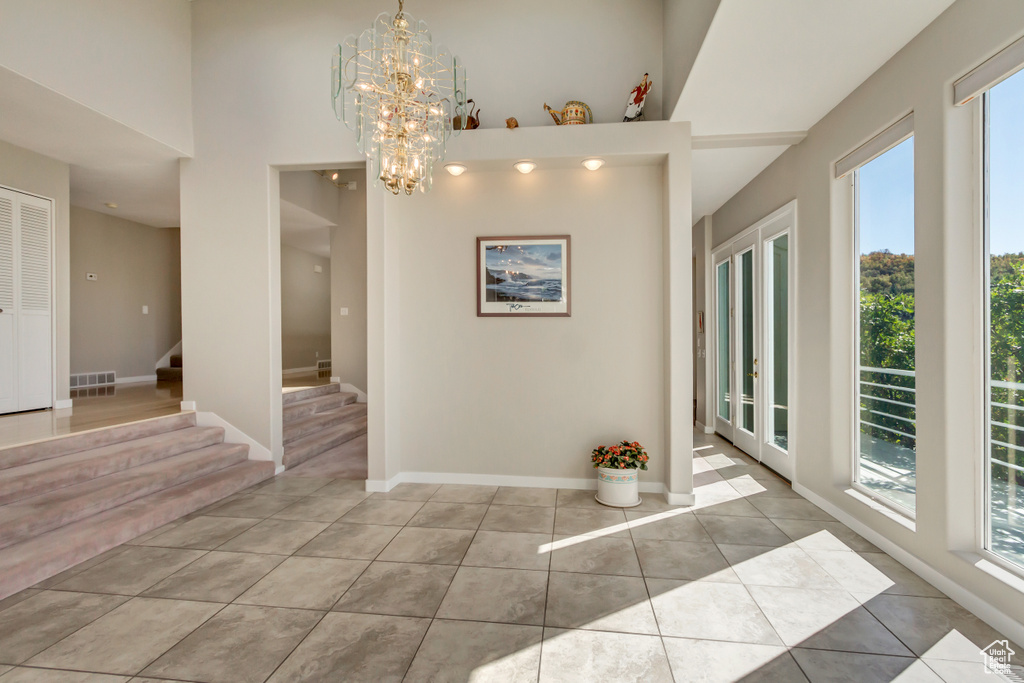 Unfurnished dining area with an inviting chandelier and light tile patterned floors