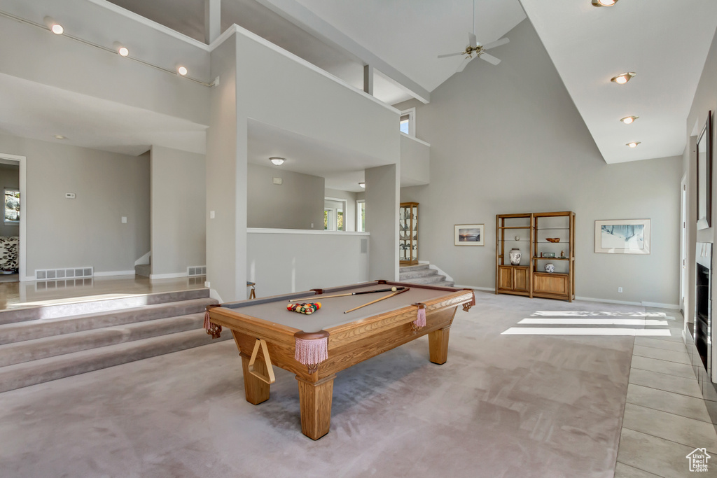 Playroom with pool table, ceiling fan, light colored carpet, and high vaulted ceiling