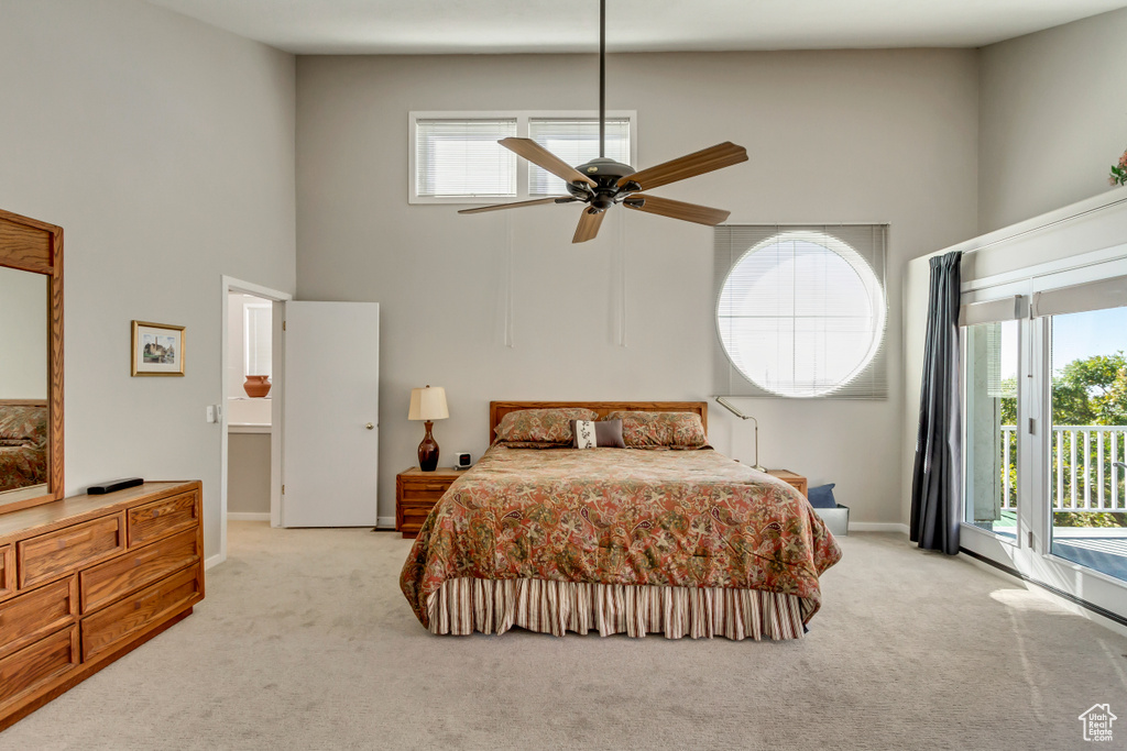 Bedroom with access to outside, light colored carpet, and ceiling fan