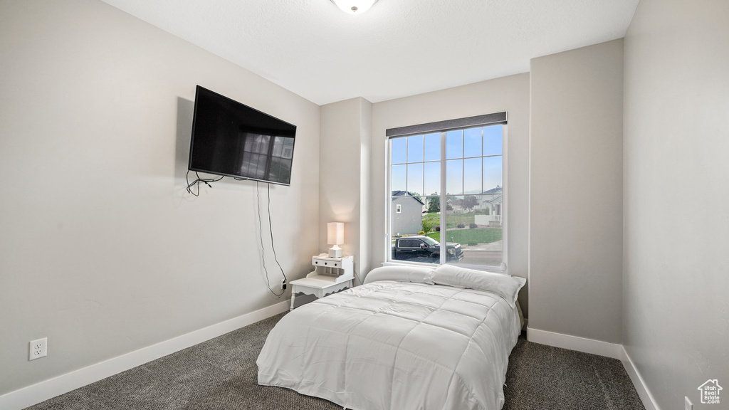 Bedroom with carpet flooring and baseboards