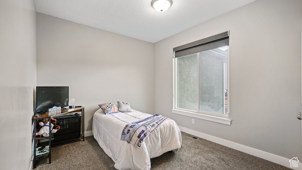 Carpeted bedroom featuring baseboards