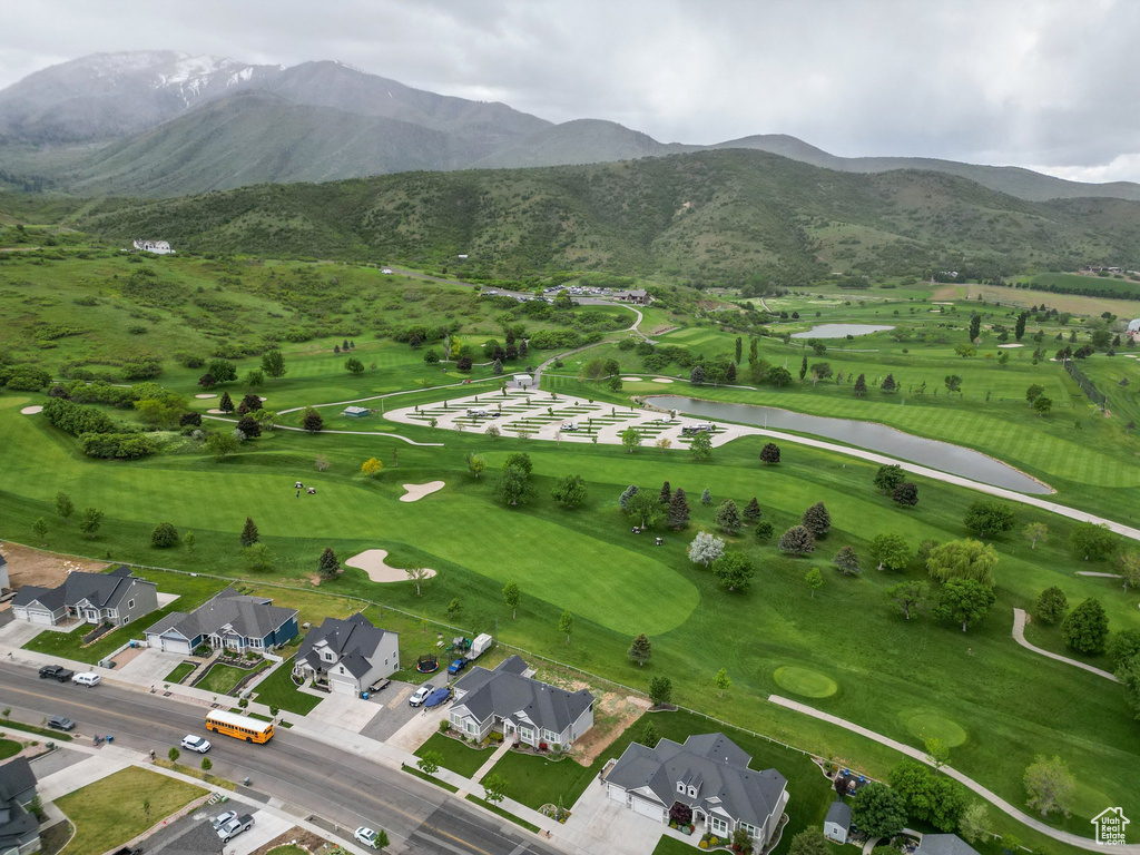 Aerial perspective of suburban area with a water and mountain view and a golf club