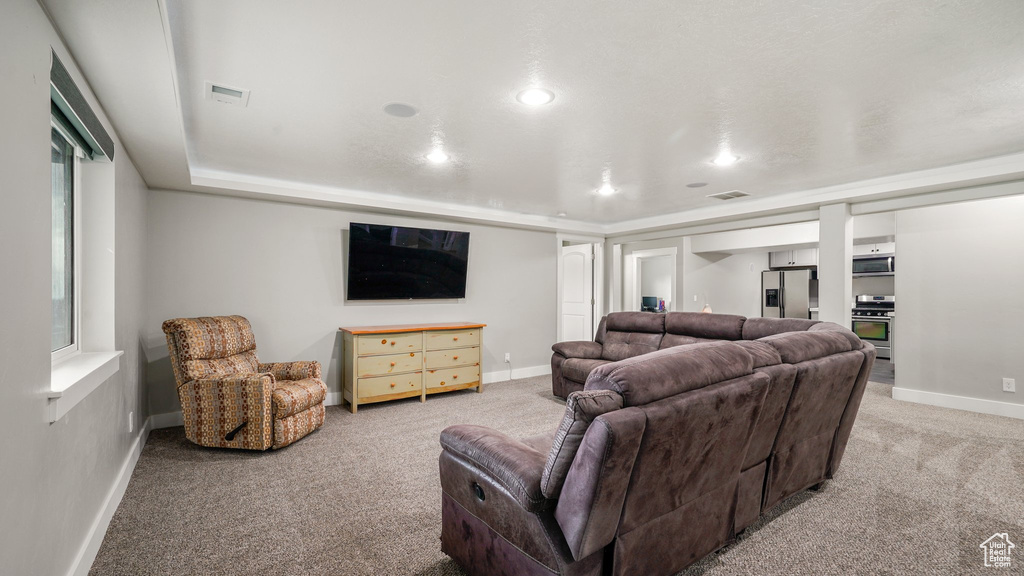 Carpeted living room featuring baseboards and recessed lighting