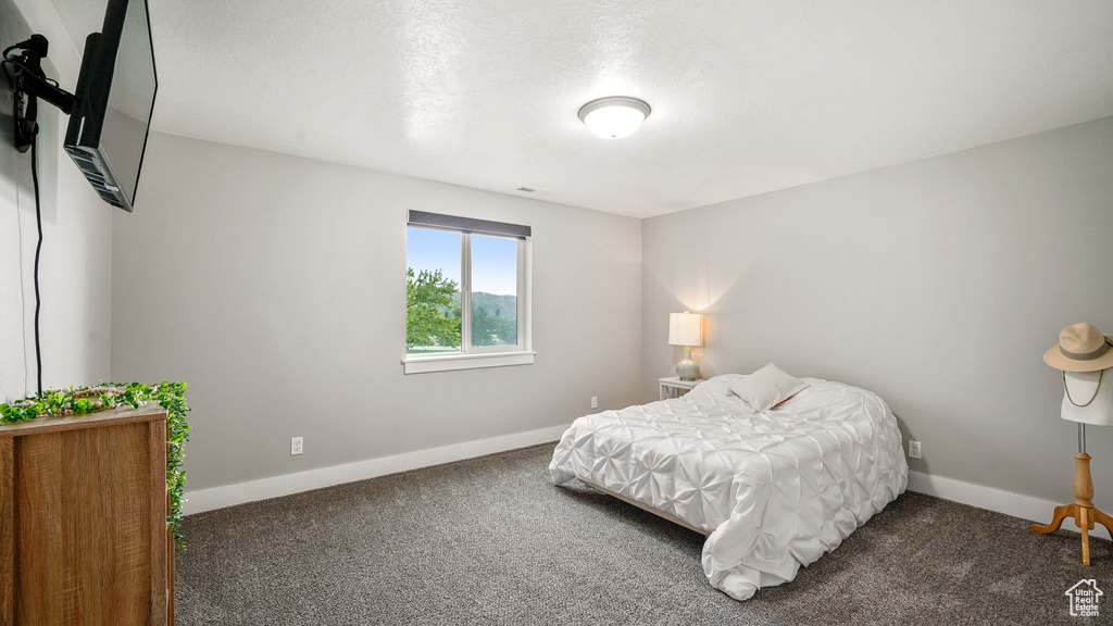 Carpeted bedroom with baseboards