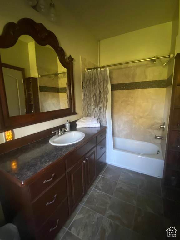 Bathroom with shower / bath combo and vanity