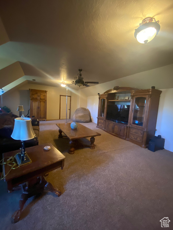 Carpeted living room with ceiling fan