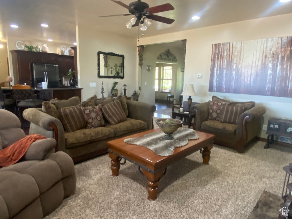 Living room with light carpet and ceiling fan