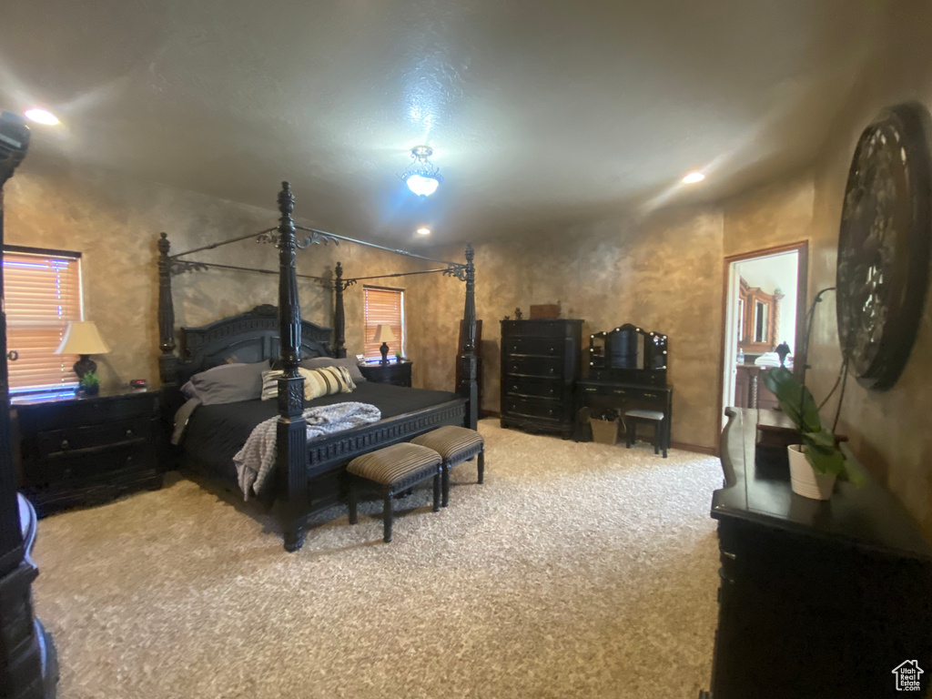 Bedroom featuring carpet and lofted ceiling