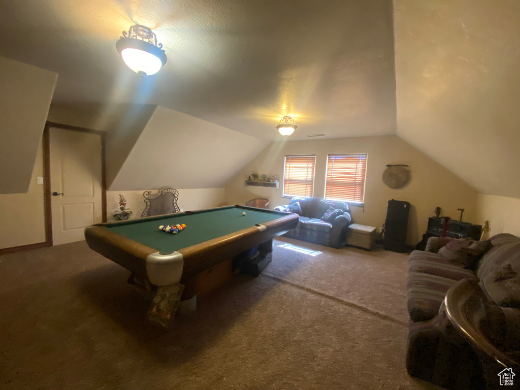 Game room with pool table, vaulted ceiling, and carpet floors