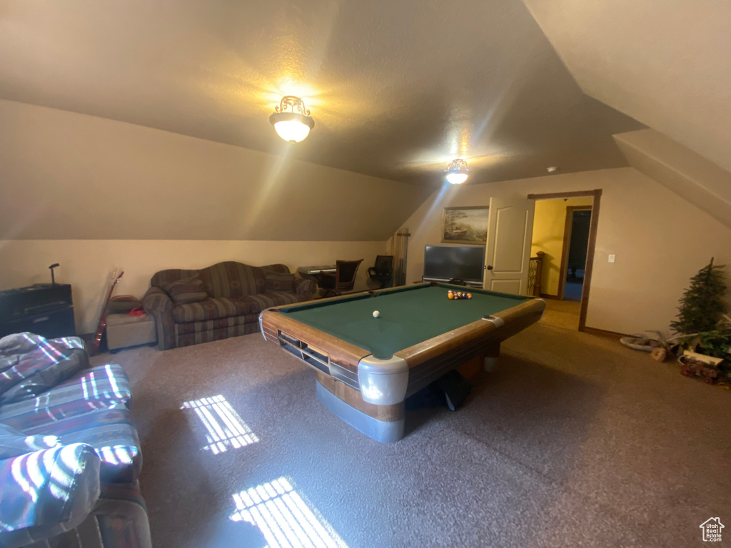 Game room with pool table, carpet, and vaulted ceiling