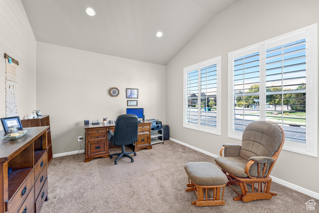 Carpeted office with vaulted ceiling