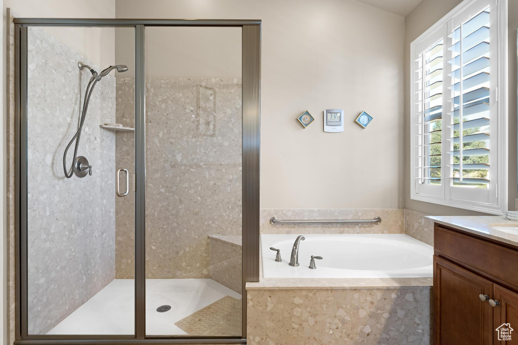 Bathroom with vanity and shower with separate bathtub