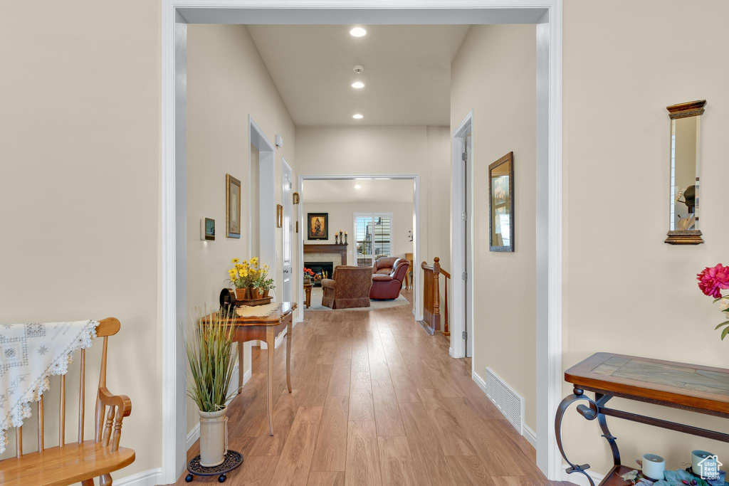 Hall with light hardwood / wood-style floors