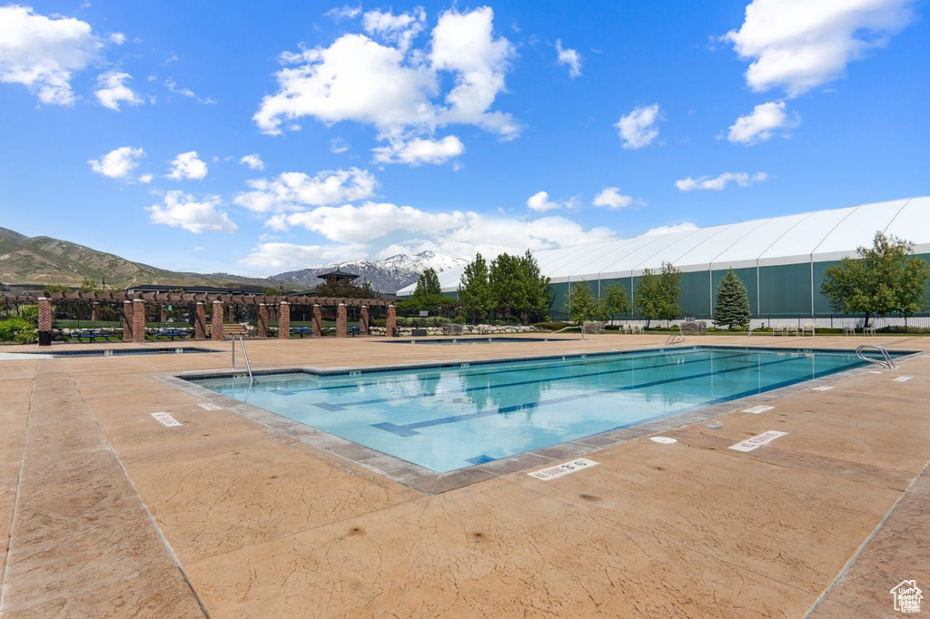 View of pool featuring a mountain view and a patio area