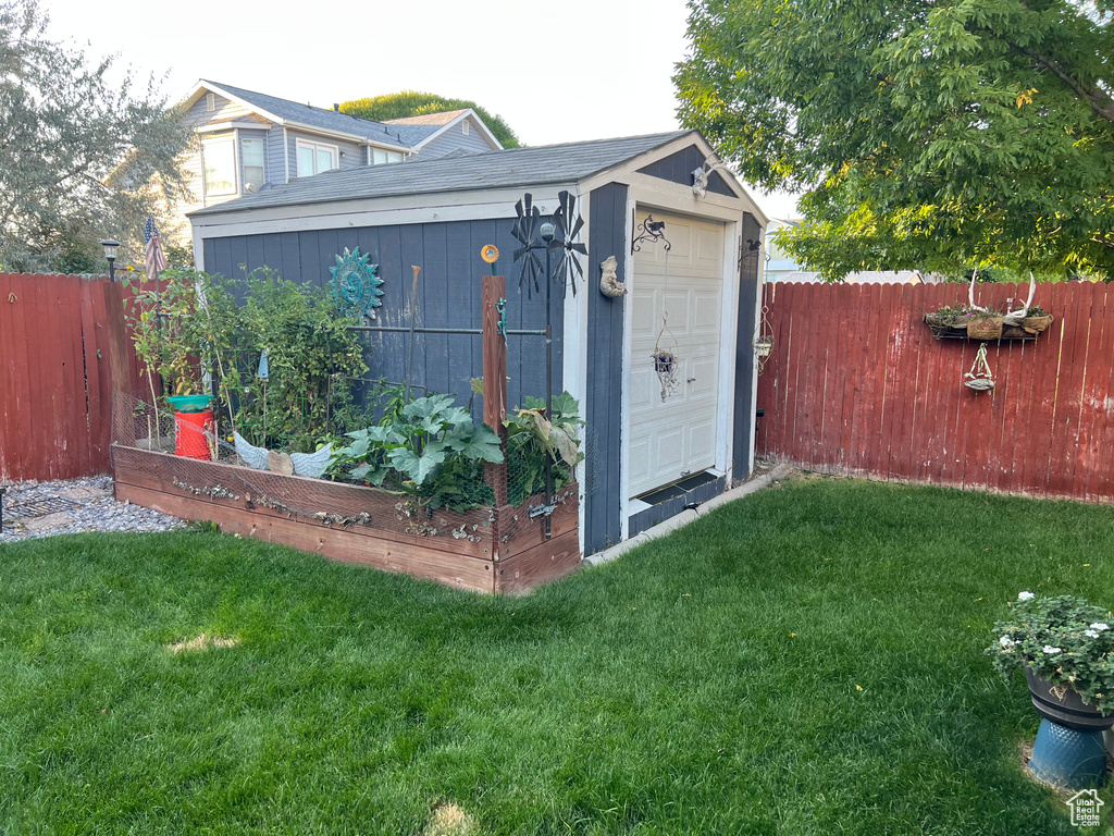 View of outbuilding featuring a lawn